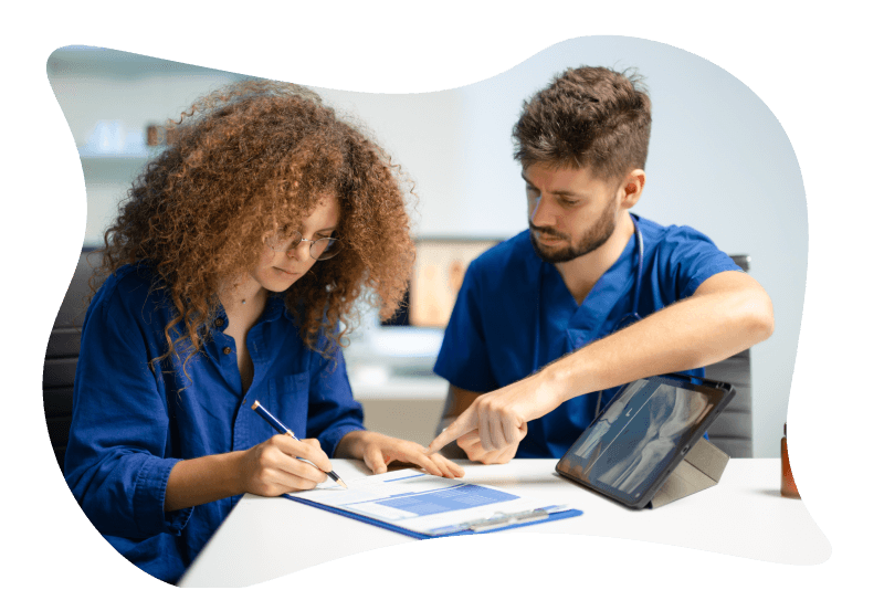 A nurse and a patient going over patient intake scan forms together.