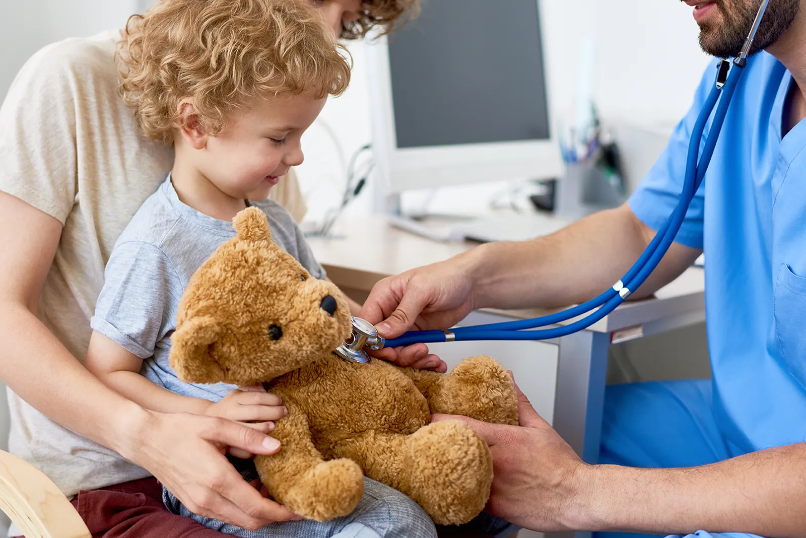 Older child and toddler together in a pediatric office