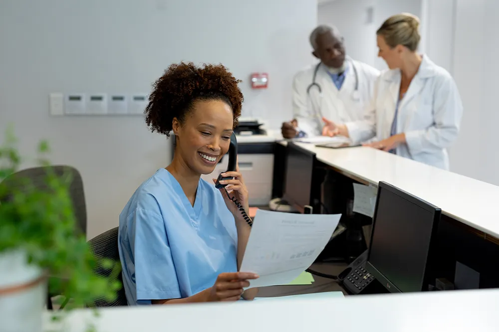 Clinical staff member working with a paper patient form
