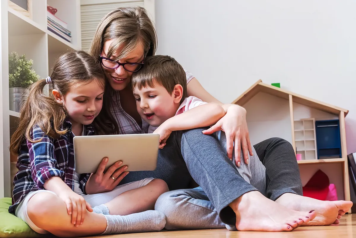 Mother and children using a tablet at home