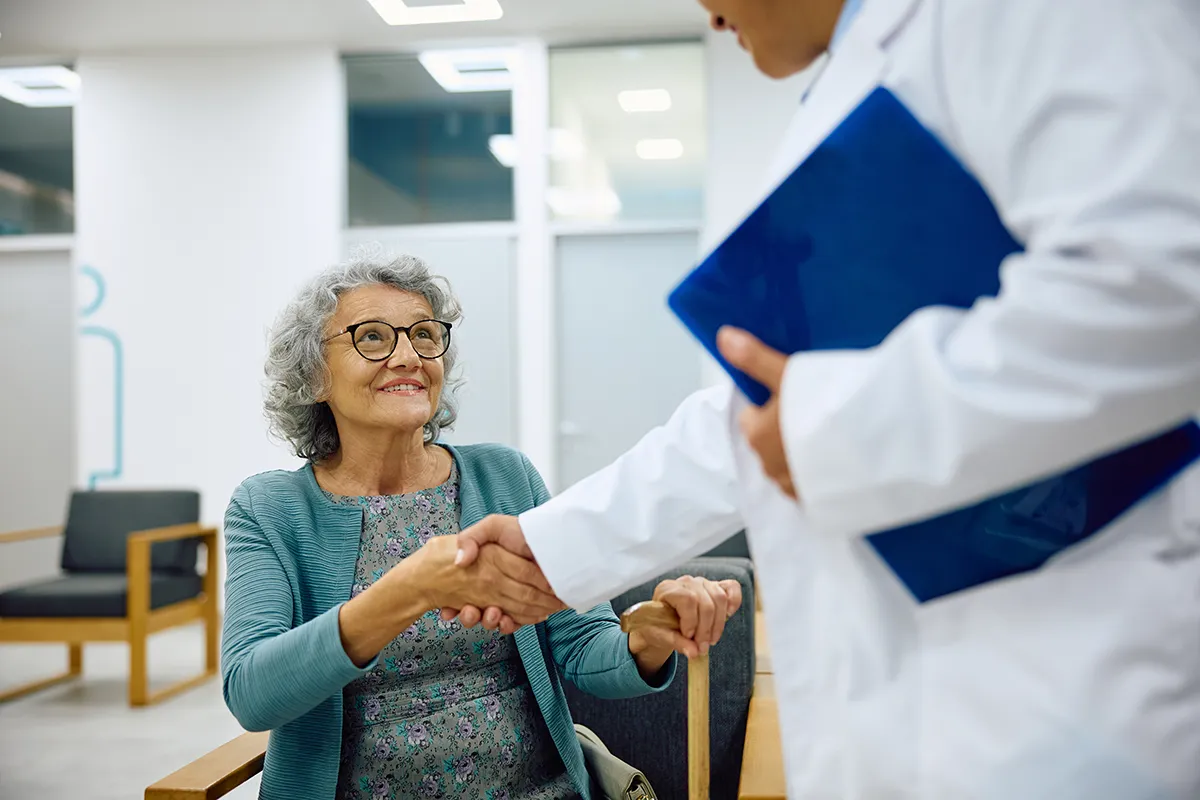Senior woman greeting her doctor in a medical clinic